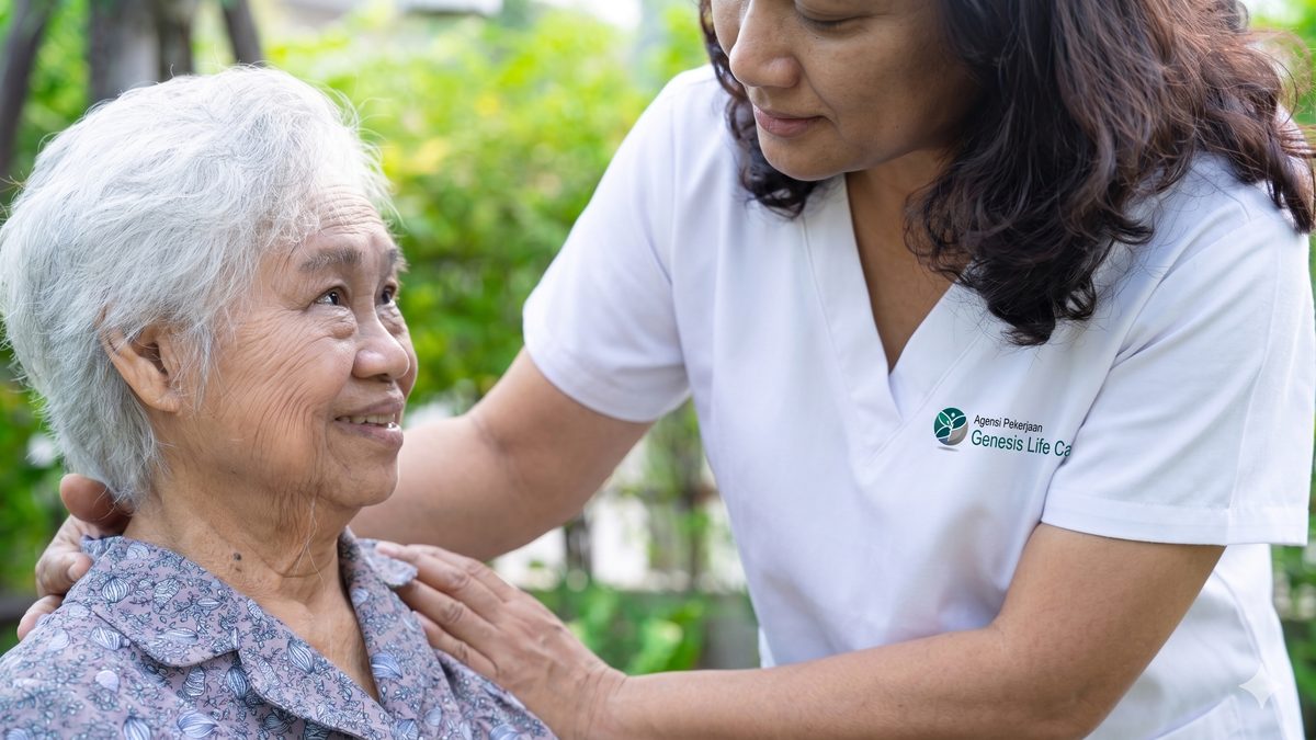 Genesis Life Care caregiver helping elderly woman — professional maid and caregiver placement Malaysia